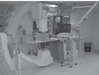 Figure 1. U-arc Philips H 3000 equipment utilized in interventional radiology with an image intensifier, two overhead monitors and patient table with controllers.