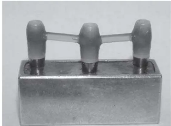 FIGURE 1- Waxed-up bar incorporating prosthetic cylinders