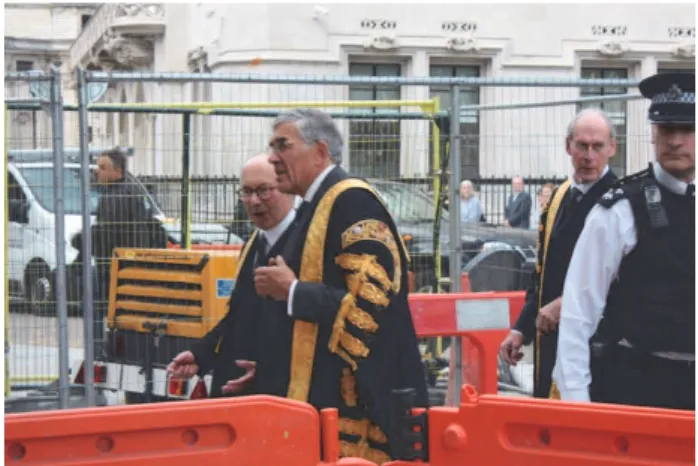 figure  1  Justice  of  the  Supreme  Court  on  the  pedestrian  crossing  amongst road building equipment