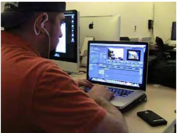 Figure 14 - Student editing video in his own laptop,  with headphones and with his cell phone close by