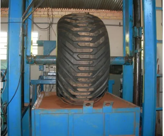 FIGURE 1. Hydraulic press pressing the tire onto the box of soil 