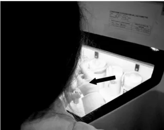 Fig.  2  presents  a  technologist  wearing  the  dosimeter  EPD-MK2  (pointed  out  by  the  arrow)  during  the  transportation  of  the  shielded  syringe