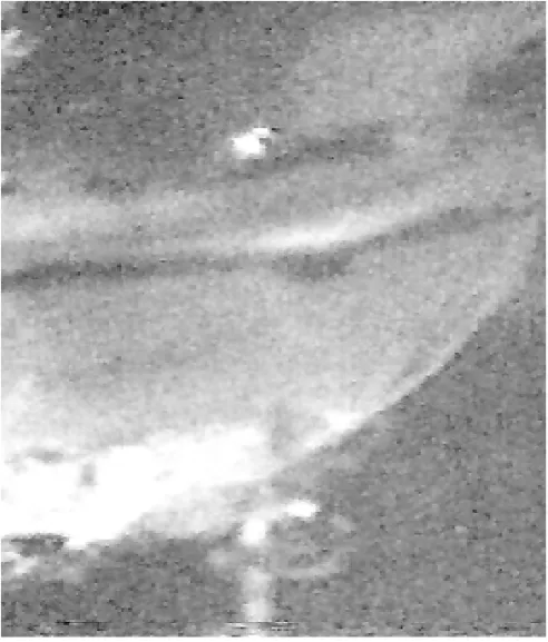 Fig. 6 – Detail of the laser beam touching the tip and shaft of the tungsten electrode inside the lens and leaving the lens below