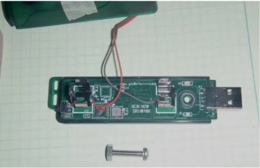Fig. 1. Datalogger with the casing partly removed. The USB connector is at right, the AA battery terminals are visible at right and left (with user-supplied wires soldered there to provide an alternative power supply in this application)
