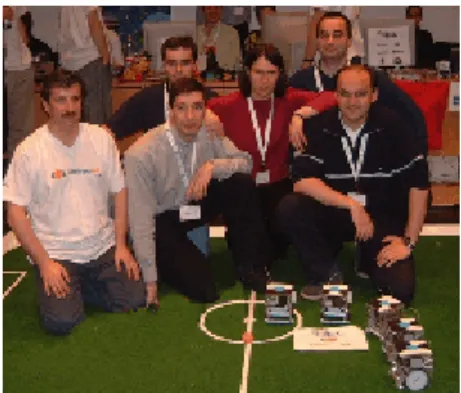 Fig. 5. Human team also showing robot's bar codes at German Open 2002 (old 5dpo robots on the right side of the picture, with blue team colour)
