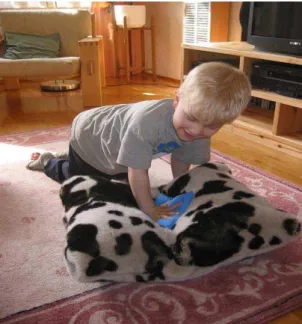 Figure 3 .  A child informant uses a beanbag to experiment with the sounds that the pillow prototype makes