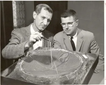 Figure 1. William E. Gordon and William McGuire working with a late 1958 model of the Arecibo radar dish and feed system.