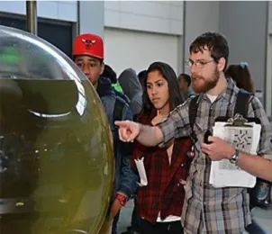 Figure 2. Museum visitors learning from MAT graduate