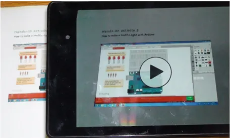 Fig. 1. The video is triggered and displays in the mobile device (smartphone or tablet) the circuit assembly with the augmented reality app.