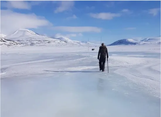 Figure 3.3. An example of an icing in Adventdalen, Spitsbergen, Svalbard with person for scale