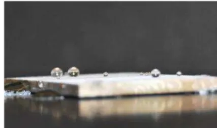 Figure  1  –  water  droplets  lying  over  a  Mg  plate  covered  with  two  water-borne  superhydrophobic  top- top-coats 