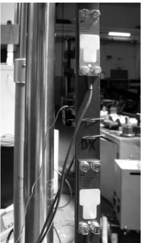 Figure 5: Setup for the SLB-700A comparison tests.  The bar is placed vertically between the loading machine   grips