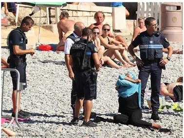 Figura 1: Mulher autuada por utilizar trajes de banho islâmicos  Fonte: Diário de Notícias 