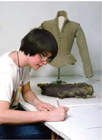 Figure 6 – Conservator Susan Stanton completing the documen- documen-tation of the Reigate doublet; she made the replica doublet seen in the background (TCC 1851).