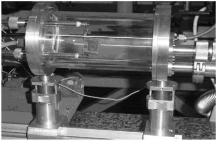 FIG. 1: MHCD device attached to electrodes and seated inside cylin- cylin-drical quartz discharge chamber.
