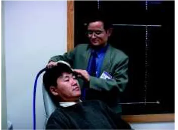 Figure 1 - Application of transcranial magnetic stimulation (TMS): Xingbao Li, M.D. applies the figure-eight electromagnetic coil over Jeong-Ho Chae, M.D.’s left prefrontal cortex.