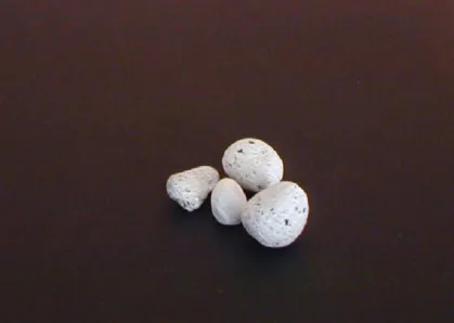Figure 7 –  Set of four small well-worn, very smooth pumice stones used in stonewashing laundry to  give it its worn look.
