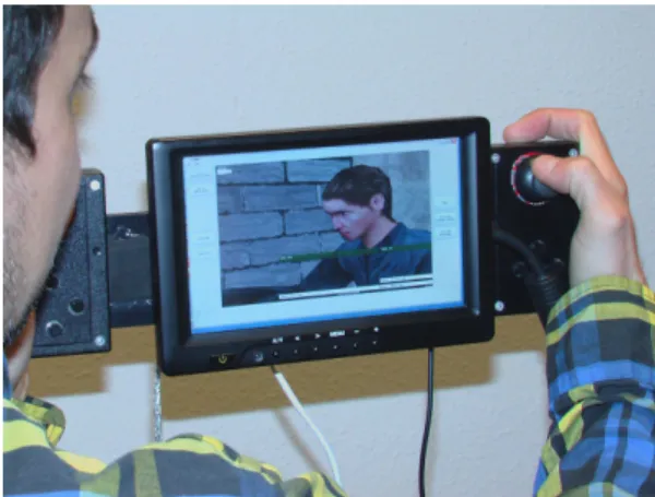 Figure 4: Our hand-held virtual camera device with custom-built dual handgrip rig and button controls, a 7-inch LCD touch-screen.