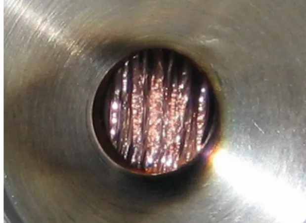 FIG. 2. Beam-induced changes observed for the 50 Ti plunger target. The originally stretched target foil was severely damaged.