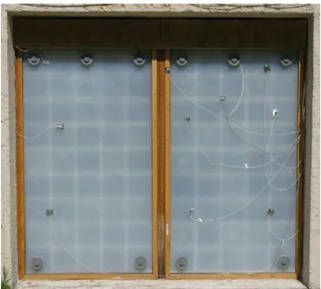 Figure 2 shows an external view of the PCM-aerogel wall. The six valves on top of the  wall are used to fill in the gap behind the glazing with silica aerogel material