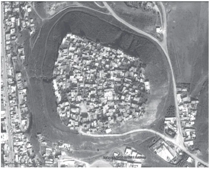 Figure 7: Aerial view of the tell in 2015. The road surrounding it has pierced the stone glacis and the earthen fill