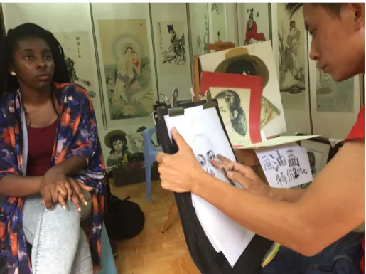 Figure 1: A visiting student has her portrait drawn in Guangzhou, China 
