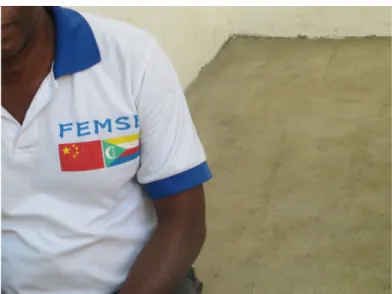Figure 5: A former driver from the FEMSE program wearing a shirt with the logo of the flags of China and the  Comoros 