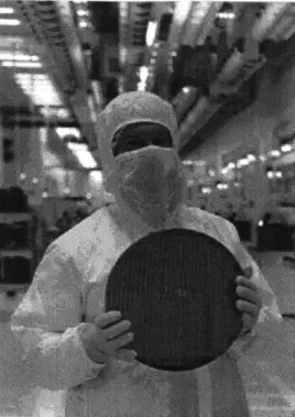 Figure  1-2:  A  worker  on  a CMOS  silicon  fabrication  line.  Image  from  [135].