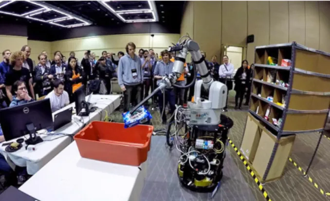 Fig. 1. The RBO team’s robot placing a pack of Oreo cookies that it retrieved from the warehouse shelf into a tote