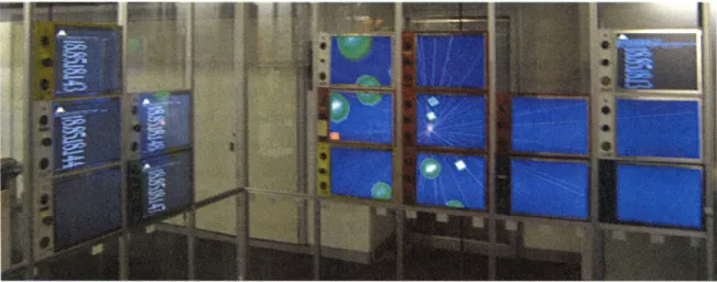 FIGURE  5.4.  Example  of SAS  tiles mounted on a frame  along two glass walls.  A distributed  data display can  be seen across the screens of one