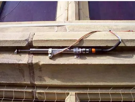 Figure 3. A photo (PT991119) showing a displacement sensor tucked under a windowsill to  monitor movement across a repaired crack