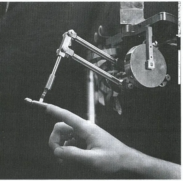 Figure 1-1: Massie and Salisbury’s PHANToM haptic interface exerts a controlled force onto a user’s finger tip to provide haptic feedback