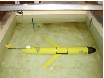 Figure 3: Photograph of a SLOCUM glider suspended from two  spring-scales being ballasted for zero pitch and zero roll angle in  our freshwater ballast tank