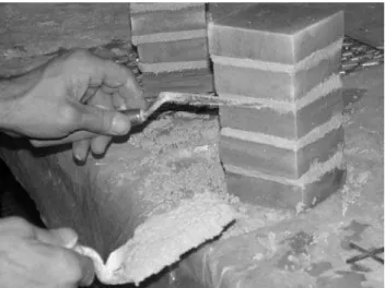 Figure 1   Mortar joints being finished flush with surface after construction of the  masonry prism