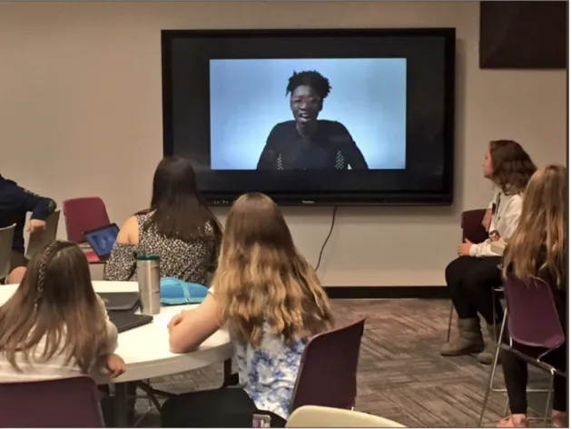 Figure 7-2: Students watch as scholar Joy Buolamwini explains her research showing that commercial facial recognition systems work better on lighter skinned male faces than darker skinned female faces.