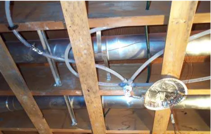 Figure 6.  Pipes and fittings on open wood joists in recreation room.