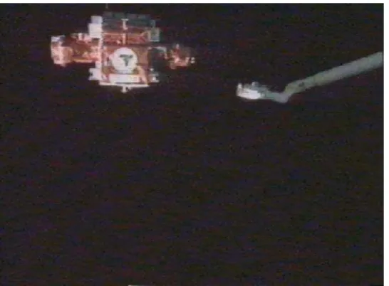 Figure 1 Grasping of a free-floating satellite with Canadarm. The satellite in the bottom