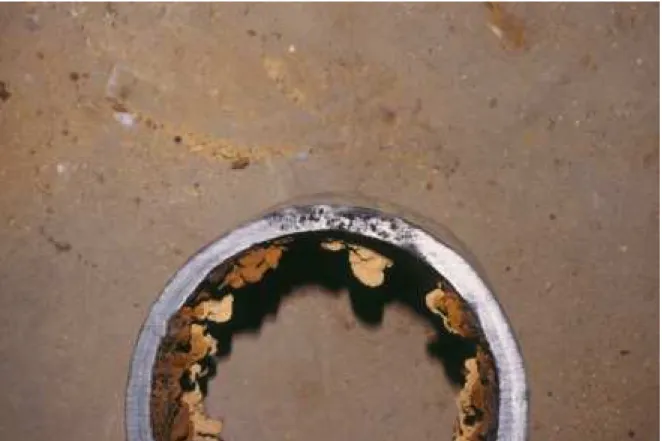 Figure 2  A region of air pockets along the edge of a 150 mm pipe.  The black colouring is due to the oxidation of the metal by the trapped air during the casting process.