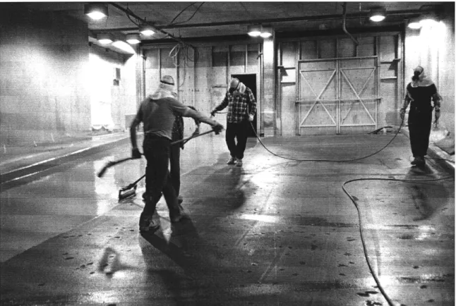 Figure 1.  Application of an elastomeric waterproofing membrane by spraying and back rolling
