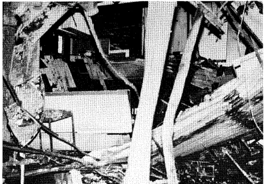 Fig.  12  (Right) Partial collapse of  primary  girder showing shear failure  of  weld  connection between angle  and  column 