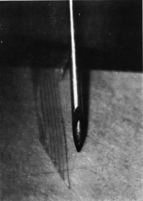 Fig.  XVIII-7.  Microphotograph  of  electrode  array;  object  at  right  is  No.  27 hypodermic  needle  (