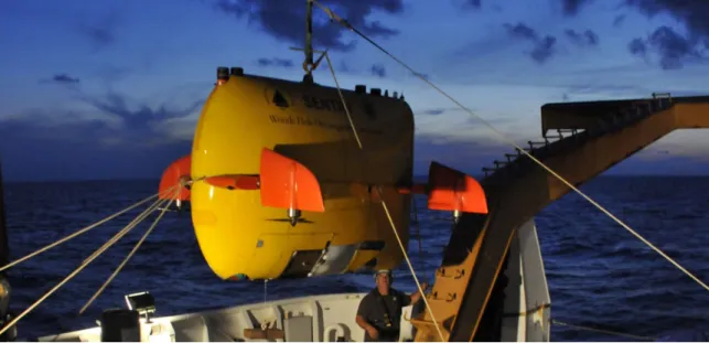 Figure 0-2: NDSF AUV Sentry being raised for launch. Two pairs of control fins with thrusters enable close bottom-following