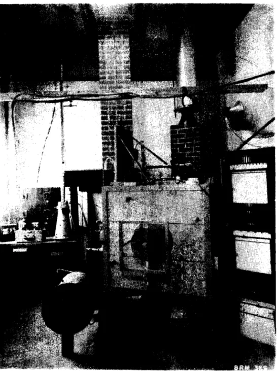 Figure  2  View  of  chimney  laboratory  with  t h e   propane  furnace  i n  t h e   foreground,  t h e   f u l l - s c a l e   b r i c k   chimney  a t  centre  and  t h e   s h o r t   t e s t   chimney  a t  t h e   r i g h t 