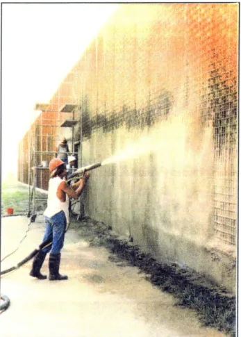 Figure  2.3:  A  construction  worker  spraying  the  Truss Panels  with  light  weight  concrete.