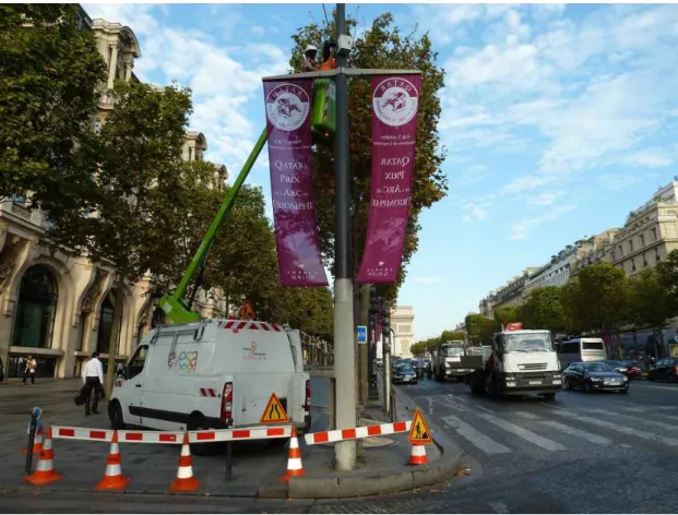 Figure 4.11 – Cradle and workmen installing beacon B 2 on a streetlight pole on the Champs Elysées.