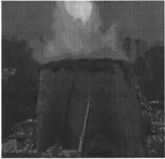Figure  2-2:  Firing Bricks.  A  photo  of  the  brick  firing  process  in  Uganda.  The standard  practice  is  for  a kiln  to be  erected  from  unfired  bricks