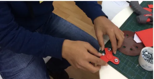 Figure 10: As part of the newly instated Activity Class, one minor builds a fidget spinner out  of cardboard and spare nuts while also being introduced to the Horizon Center program