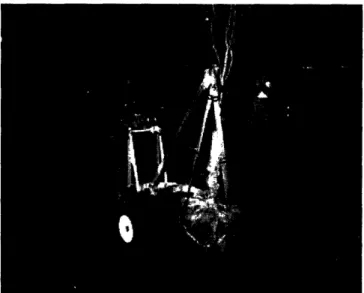 Figure 10: Mockup of the Winch Model being used to plant a tree. The  outriggers, which are painted  orange, are successfully being  used to prevent the  device from  tipping  while the tree is being lowered.