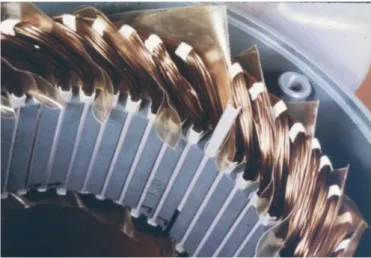 Figure 24: Slot wedges and phase insulation seen with the winding in place; one wedge is partially inserted [43] 