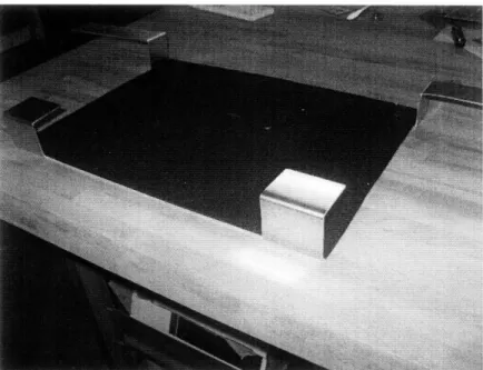 Figure  6:  The  bottom  straps of the laptop  holder  secure  the laptop  using compressive  force.
